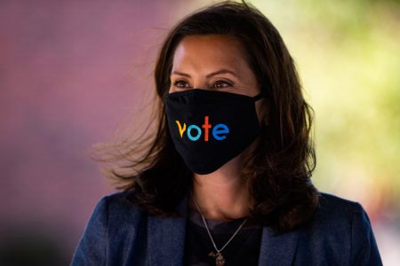 Michigan Gov. Gretchen Whitmer wears a mask with the word vote displayed on the front during a roundtable discussion on healthcare, Wednesday Oct. 7, 2020, in Kalamazoo, Mich. (Nicole Hester/Ann Arbor News via AP)