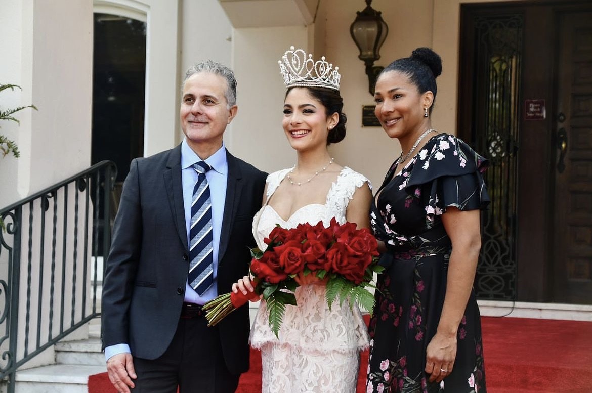 Newly crowned Rose Queen Naomi Stilitano poses for a picture with her parents.