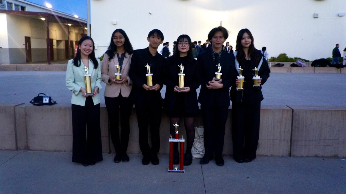Arcadia Speech and Debate members with their winning trophies. 
  (Left to right) Evelyn Tsoi, Avani Athavale, Howie Liang, Rae Manzon, Euan Laru-An, and Michelle Fan. 
