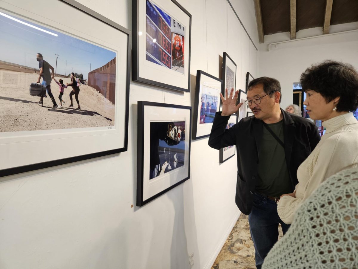 Ringo Chiu shows a guest around his newest exhibition, The Perfect Exposure Gallery.