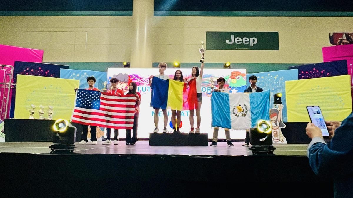 Evan Yu Girard-Sun and Emily Zhang in second place, holding the flag of the United States.