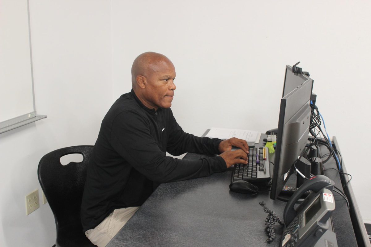 Mr. Mills working at his desk.