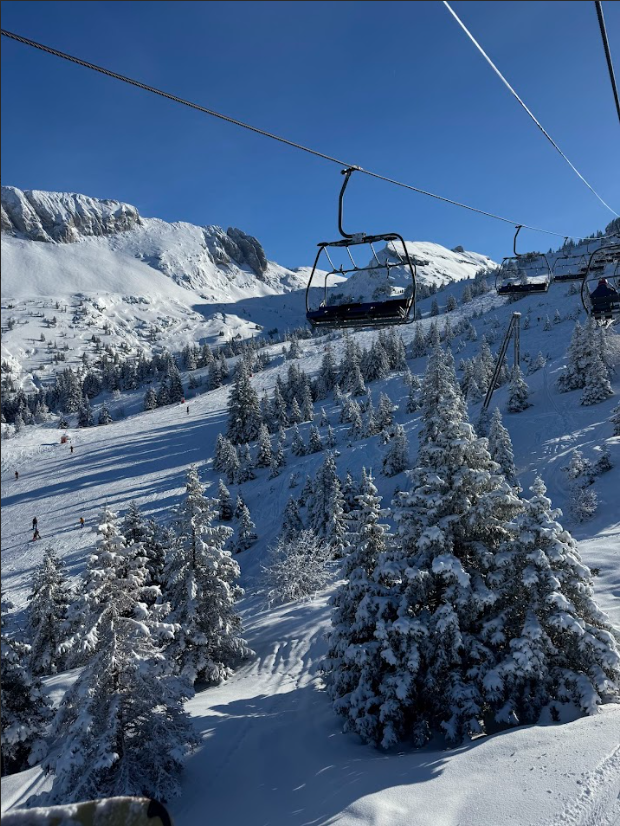 A breathtaking view from a ski lift, capturing the beautiful French Alps.