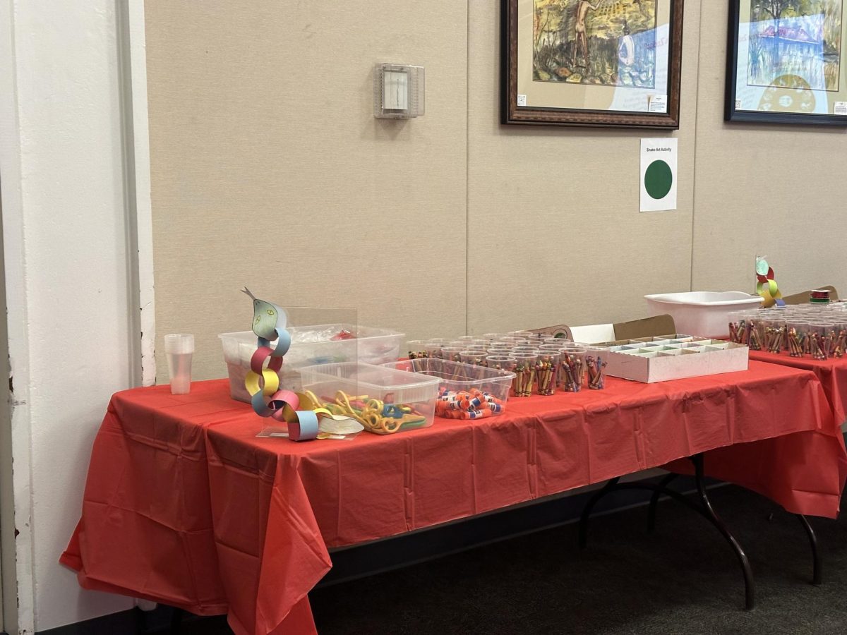 The tables were draped with red table cloth and filled with supplies ready to be used for the activities in-store