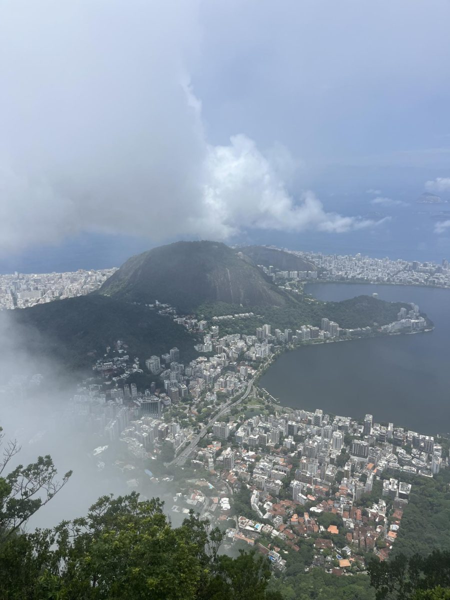 A look down into the city of Rio de Janeiro as the clouds briefly part, with a stunning view of Copacobana Beach. 