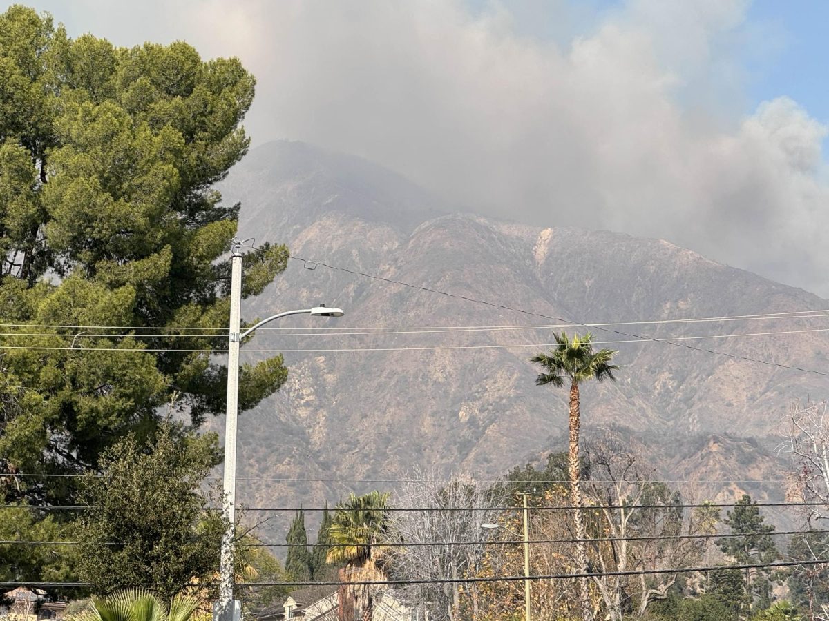 Wildfire smoke continues to rise into the air on the morning of Jan. 8.